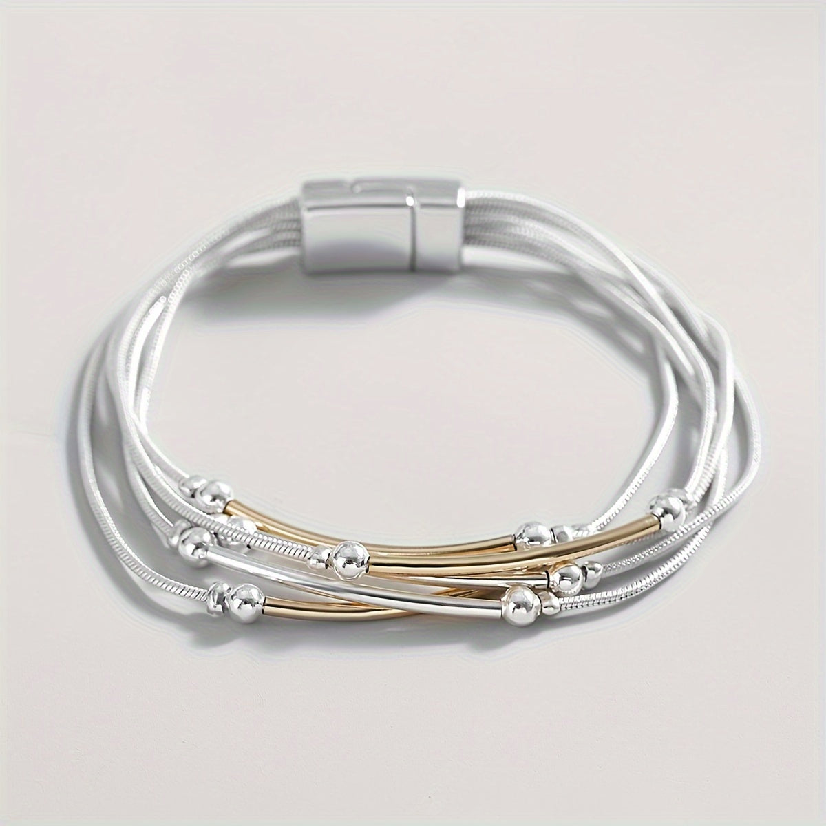 Multilayered silver chain bracelet with gold and silver beads 